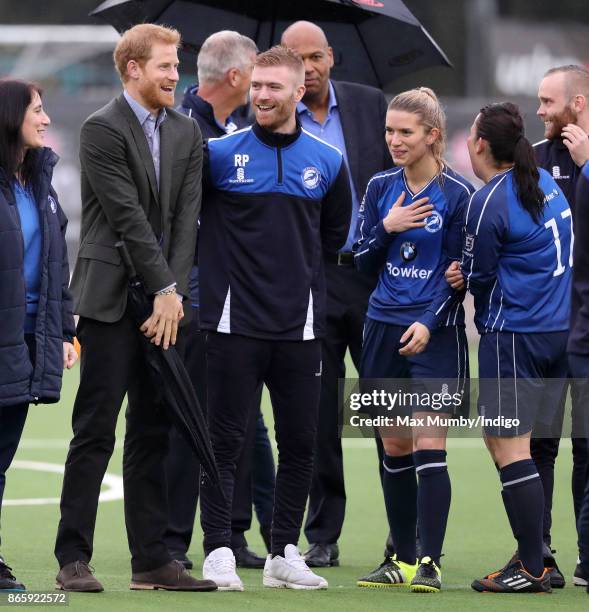 Prince Harry reacts as he watches a football training session during a visit to the Sir Tom Finney Soccer Development Centre at the UCLan Sports...