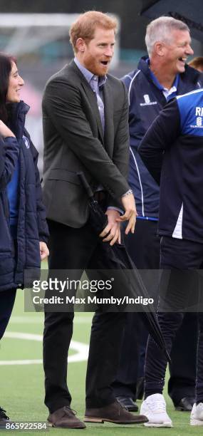 Prince Harry reacts as he watches a football training session during a visit to the Sir Tom Finney Soccer Development Centre at the UCLan Sports...