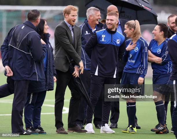 Prince Harry reacts as he watches a football training session during a visit to the Sir Tom Finney Soccer Development Centre at the UCLan Sports...