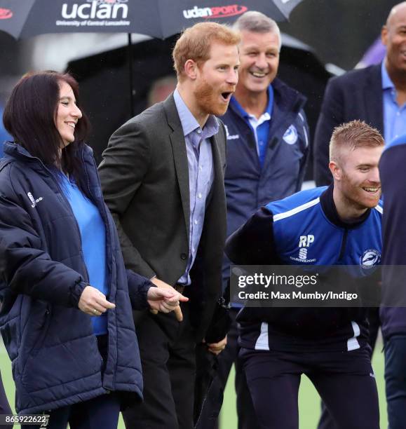 Prince Harry reacts as he watches a football training session during a visit to the Sir Tom Finney Soccer Development Centre at the UCLan Sports...