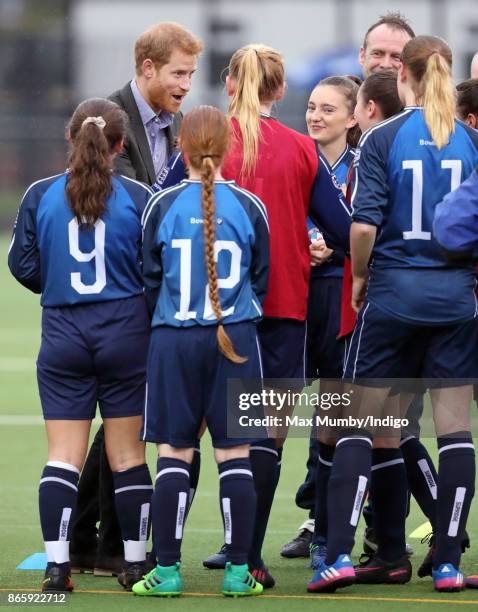 Prince Harry meets young women taking part in a football training session during a visit to the Sir Tom Finney Soccer Development Centre at the UCLan...