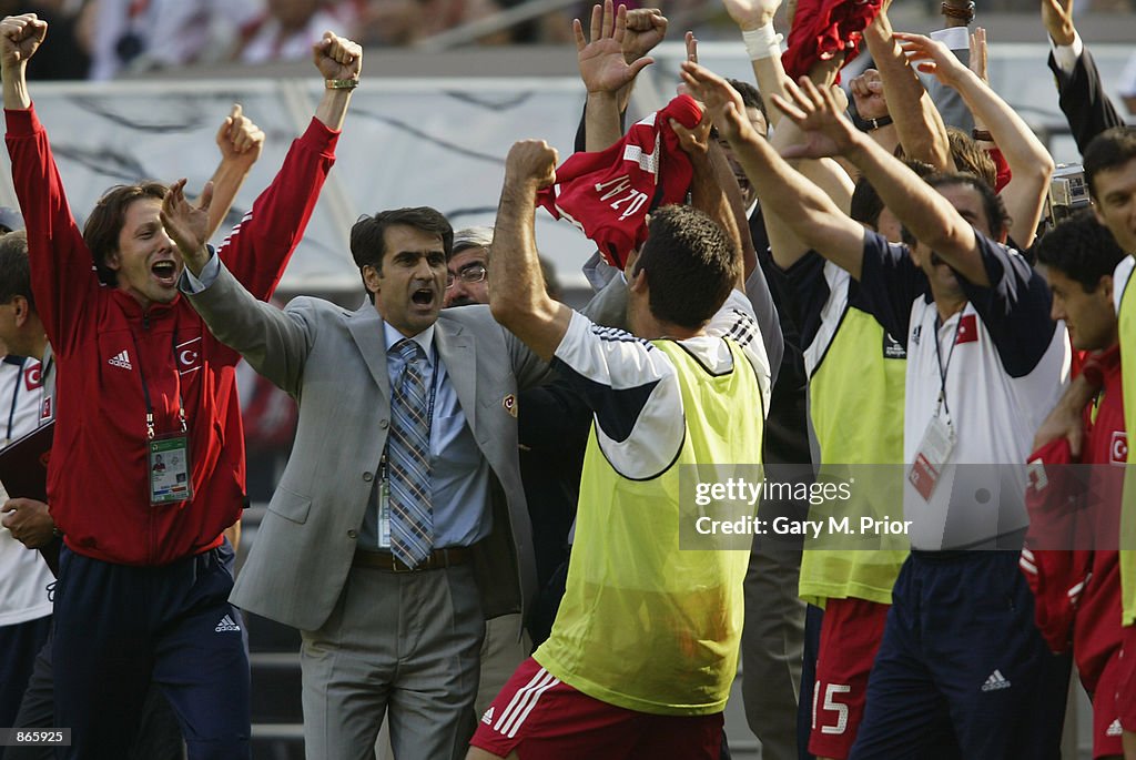 Turkey soccer coach Senol Gunes celebrates with his players