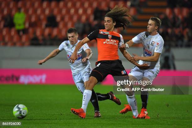 Lorient's French midfielder Matteo Guendouzi Olie vies with Caen's forward Jan Repas and Caen's French midfielder Jonathan Delaplace during the...