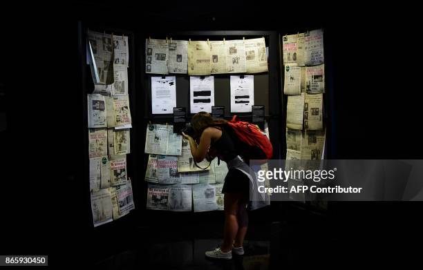 Woman takes pictures of documents exhibited at the Museum of Memory and Human Rights during "Secrets of State: the Declassified History of the...