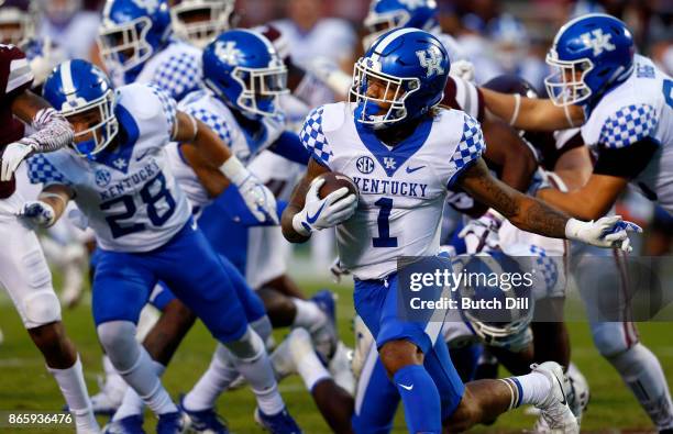 Lynn Bowden Jr. #1 of the Kentucky Wildcats tries to find a hole as he carries the ball during the second half of an NCAA football game against the...