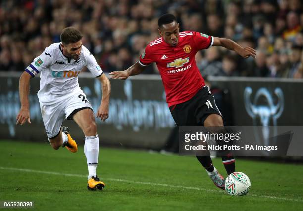 Swansea City's Angel Rangel and Manchester United's Anthony Martial battle for the ball during the Carabao Cup, Fourth Round match at the Liberty...