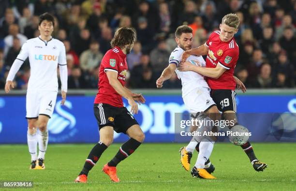 Angel Rangel of Swansea City is challenged by Scott McTominay of Manchester United during the Carabao Cup Fourth Round match between Swansea City and...