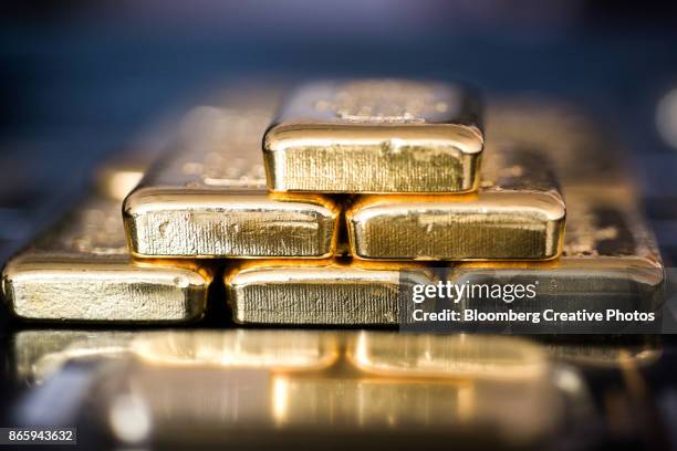 gold bars sit stacked in hungary - barren stock-fotos und bilder