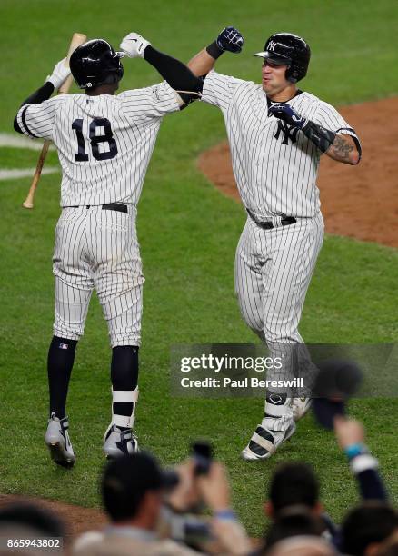 Gary Sanchez of the New York Yankees celebrates his home run with teammate Didi Gregorius in the seventh inning of game 5 of the American League...