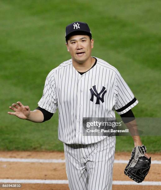 Pitcher Masahiro Tanaka of the New York Yankees reacts as he leaves the field after pitching in the sixth inning in game 5 of the American League...