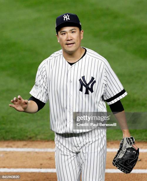 Pitcher Masahiro Tanaka of the New York Yankees reacts as he leaves the field after pitching in the sixth inning in game 5 of the American League...