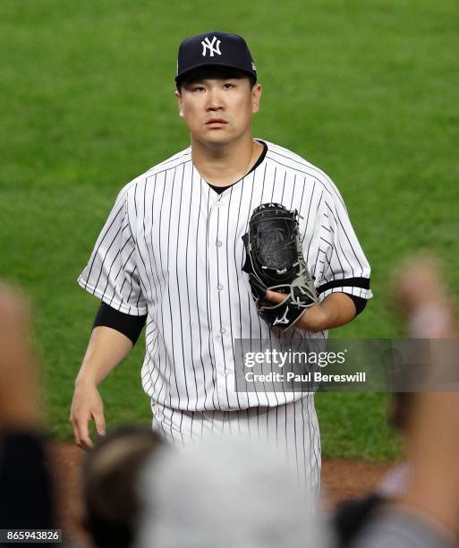 Pitcher Masahiro Tanaka of the New York Yankees reacts as he leaves the field after pitching in the sixth inning in game 5 of the American League...