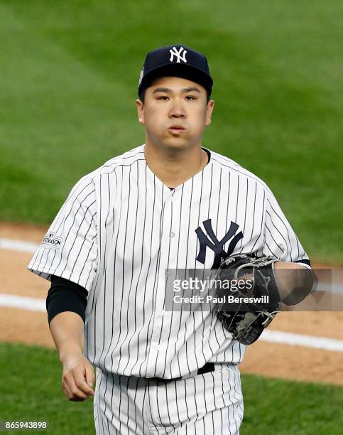 Pitcher Masahiro Tanaka of the New York Yankees leaves the field after pitching in the third inning of game 5 of the American League Championship...