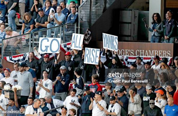 Fans dressed in robes stand to cheer in the Judge's Chambers in right field as Aaron Judge of the New York Yankees comes up to bat in the first...