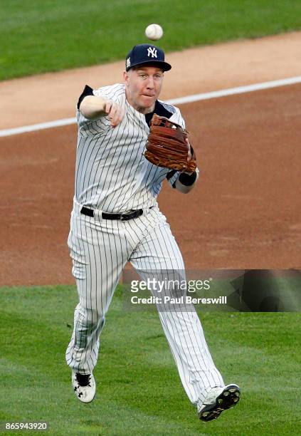 Todd Frazier of the New York Yankees throws out Carlos Correa at first base to end the first inning in game 5 of the American League Championship...