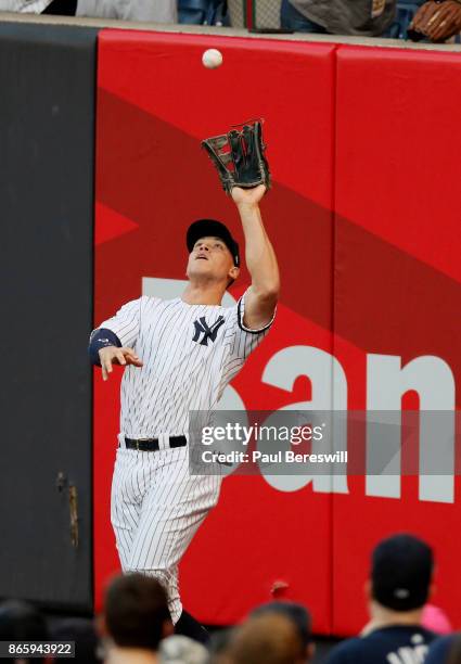 Aaron Judge of the New York Yankees goes up against the right field wall to make a catch on a fly ball hit by George Springer for the first out of...