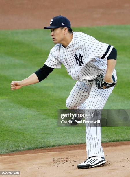 Pitcher Masahiro Tanaka of the New York Yankees follows through on a pitch in game 5 of the American League Championship Series against the Houston...