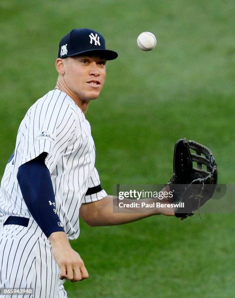 Aaron Judge of the New York Yankees catches the ball as he runs out to the outfield at the start of game 5 of the American League Championship Series...