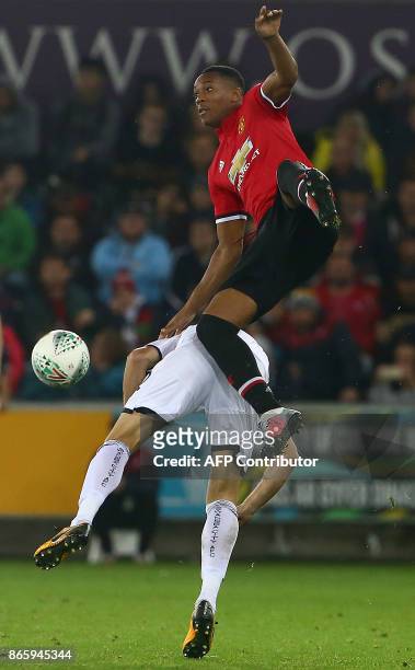 Swansea City's Spanish defender Angel Rangel vies with Manchester United's French striker Anthony Martial during the English League Cup fourth round...