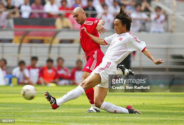Wei Du of China tackles Hasan Sas of Turkey during the first half during the Turkey v China, Group C, World Cup Group Stage match played at the Seoul...