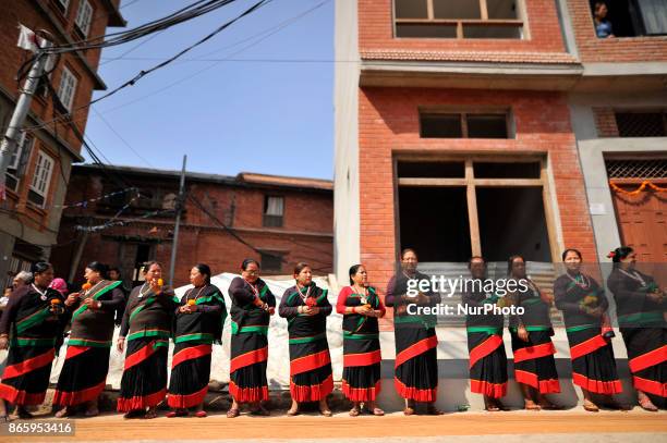 Newari community people in a traditional attire lining by holding flowers to welcome President Bidhya Devi Bhandari during inauguration ceremony of...