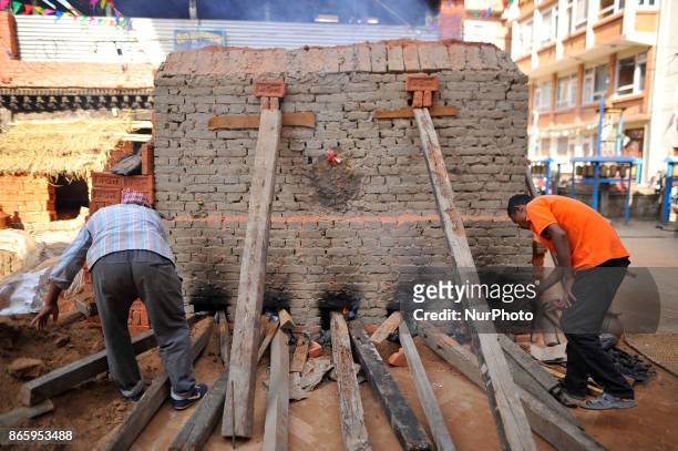 Newari community people making bricks during inauguration ceremony of Jyapu Museum on the occasion of 72nd United Nations Day in Chyasal, Lalitpur,...