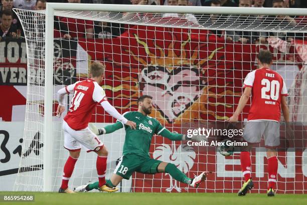 Viktor Fischer of Mainz scores his team's second goal past goalkeeper Kenneth Kronholm of Kiel during the DFB Cup match between 1. FSV Mainz 05 and...