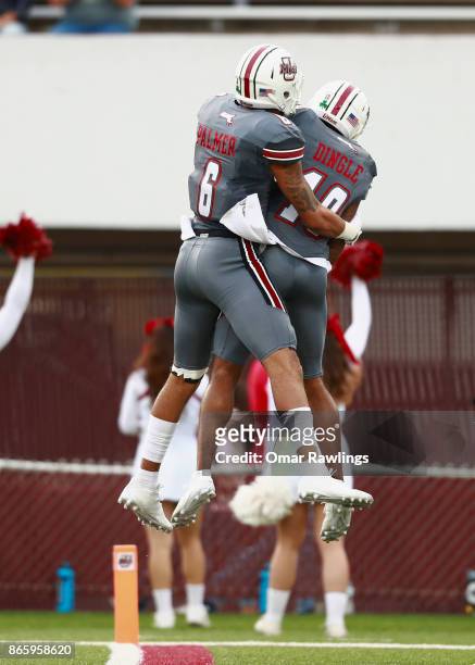 Sadiq Palmer and Brennon Dingle of the Massachusetts Minutemen celebrate after scoring a touchdown during the first half of the game against the...