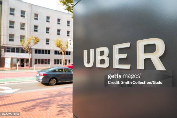 Sign with logo at the headquarters of ride-sharing technology company Uber in the South of Market neighborhood of San Francisco, California, October...