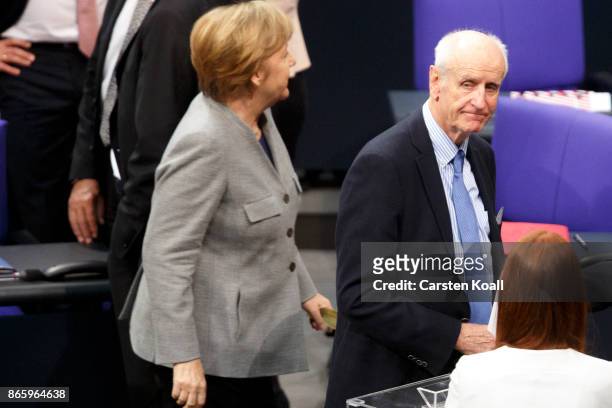 German Chancellor Angela Merkel goes pass by Albrecht Glaser of the right-wing Alternative for Germany during the opening session of the new...