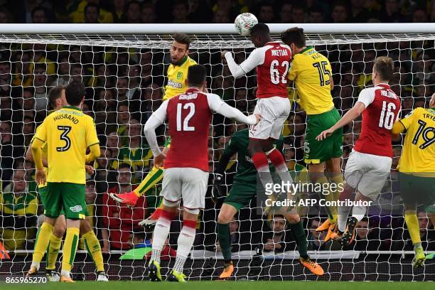 Arsenal's English striker Eddie Nketiah heads the ball to scores his team's second goal in the first half of extra time during the English League Cup...