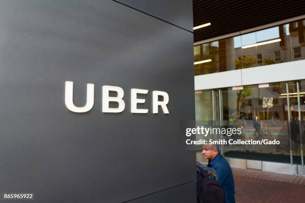 Sign with logo and entrance at the headquarters of car-sharing technology company Uber in the South of Market neighborhood of San Francisco,...