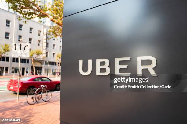 Sign with logo at the headquarters of car-sharing technology company Uber in the South of Market neighborhood of San Francisco, California, with red...