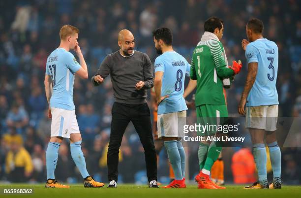 Josep Guardiola, Manager of Manchester City speaks to his players prior to extra time, during the Carabao Cup Fourth Round match between Manchester...