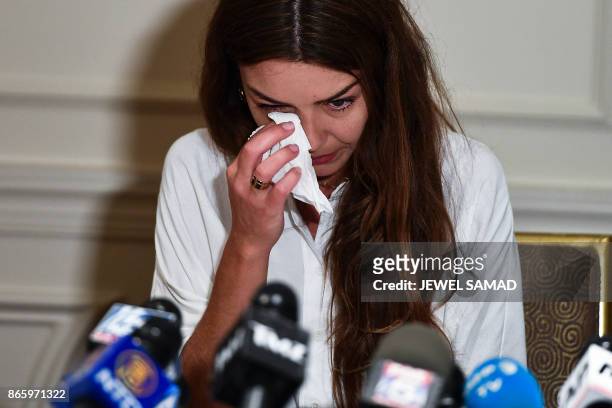 Mimi Haleyi, a former production assistant, wipes tears as she alleges being sexually assaulted by movie mogul Harvey Weinstein, during a press...