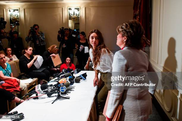 Mimi Haleyi , a former production assistant, flanked by her lawyer Gloria Allred, leaves after speaking at a press conference in New York on October...