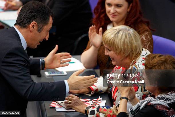 Newly-elected Bundestag Vice-President Claudia Rot receives the congratulation of co- leader of the the German Greens Party Cem Ozdemir shortly after...