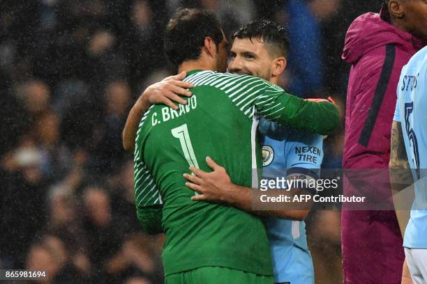Manchester City's Argentinian striker Sergio Aguero who scored the winning penalty celebrates with Manchester City's Chilean goalkeeper Claudio...