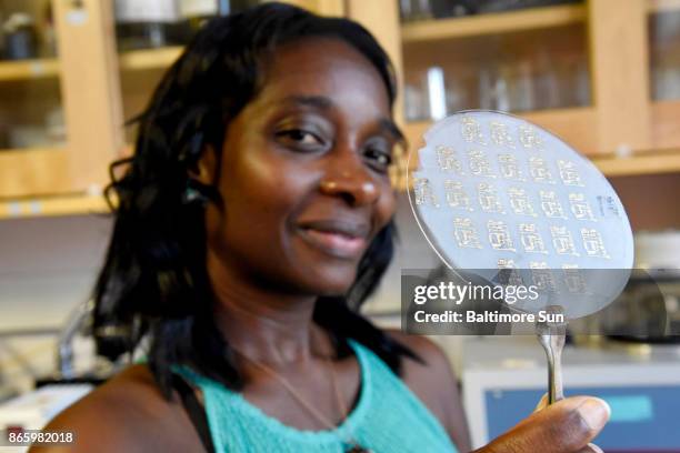 Gymama Slaughter, associate professor of computer science and electrical engineering, holds biosensors on bacterial nanocellulose designed to sense...