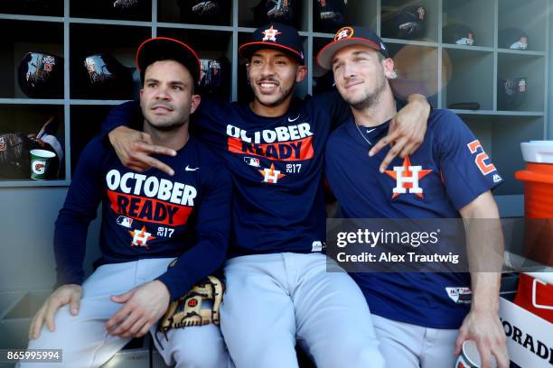 Jose Altuve, Carlos Correa and Alex Bregman of the Houston Astros pose for a photo in the dugout prior to Game 1 of the 2017 World Series against the...