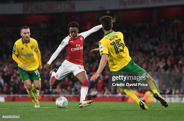 Joe Willock of Arsenal shoots under pressure from Timm Klose of Norwich during the Carabao Cup Fourth Round match between Arsenal and Norwich City at...