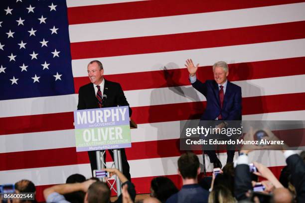 Former president Bill Clinton greets to attendees next to Democratic candidate Phil Murphy, who is running for the governor of New Jersey during a...