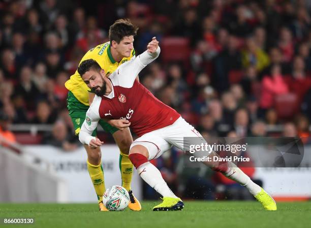 Olivier Giroud of Arsenal is challenged by Timm Klose of Norwich during the Carabao Cup Fourth Round match between Arsenal and Norwich City at...