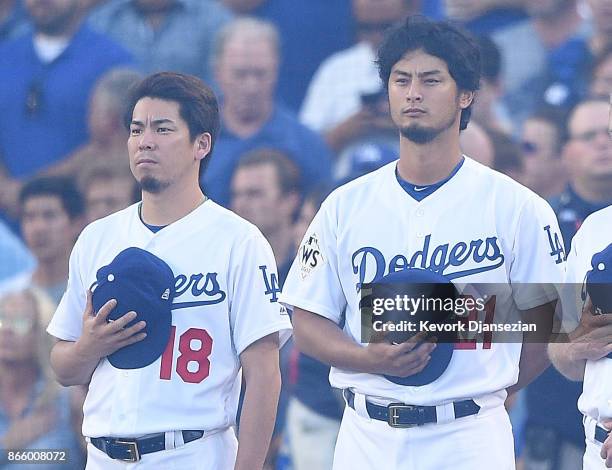 Kenta Maeda and Yu Darvish of the Los Angeles Dodgers stand during the national anthem before game one of the 2017 World Series at Dodger Stadium on...