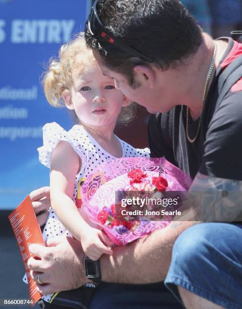 Gold Coast girl Isabella Kennedy arrives with her dad to place flowers at the entrance to Dreamworld on October 25, 2017 in Gold Coast, Australia....