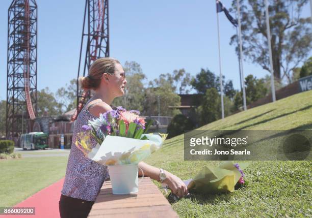 Gold Coast local Amanda Bonney arrives to place flowers at the entrance to Dreamworld on October 25, 2017 in Gold Coast, Australia. Four people were...