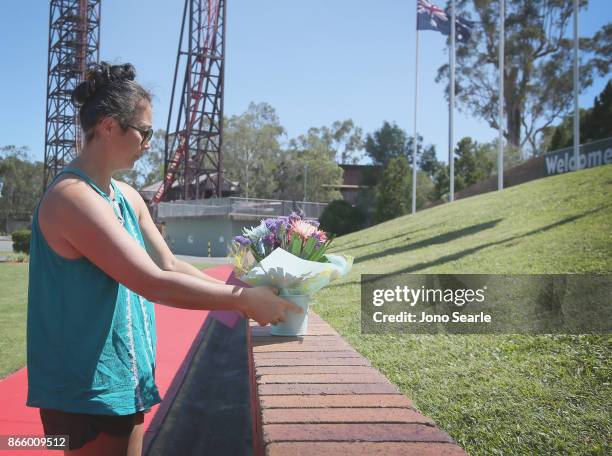 Gold Coast local Rea Lust places flowers at the entrance to Dreamworld on October 25, 2017 in Gold Coast, Australia. Four people were killed...