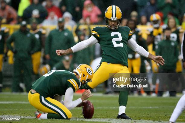 Mason Crosby of the Green Bay Packers attempts a field goal as Justin Vogel holds in the second quarter against the New Orleans Saints at Lambeau...