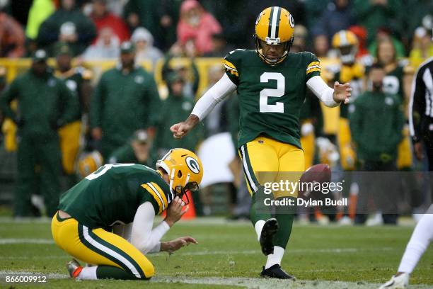 Mason Crosby of the Green Bay Packers attempts a field goal as Justin Vogel holds in the second quarter against the New Orleans Saints at Lambeau...