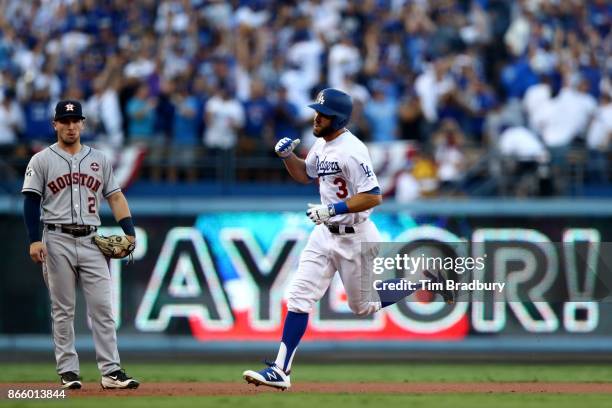 Chris Taylor of the Los Angeles Dodgers celebrates as he runs the bases after hitting a solo home run during the first inning against the Houston...